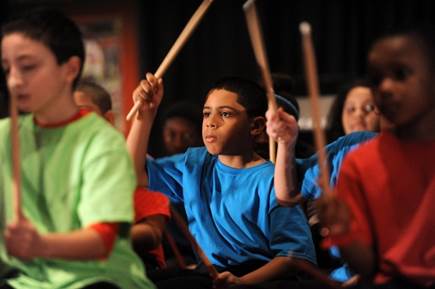 Boy from Sonido Musica playing the drums