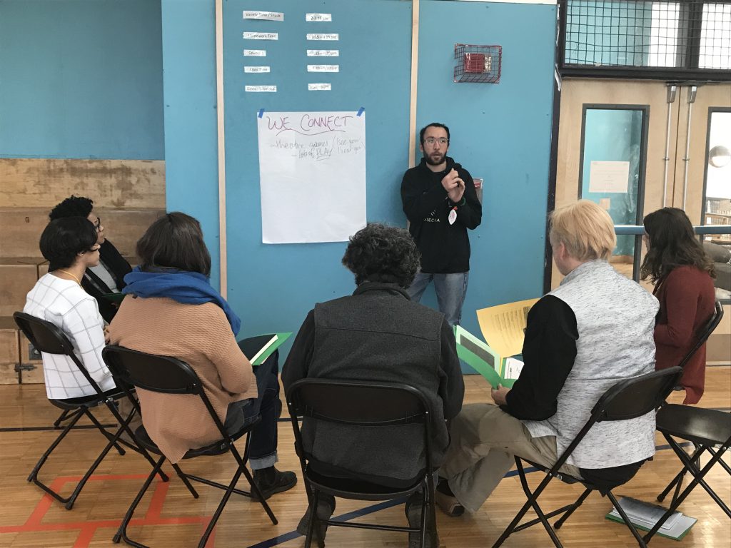 A break-out group sits around a moderator at a BEST Initiative training