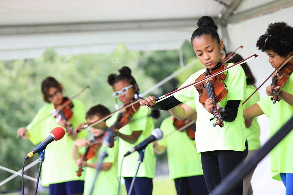 youth ensemble playing at an outside arts festival